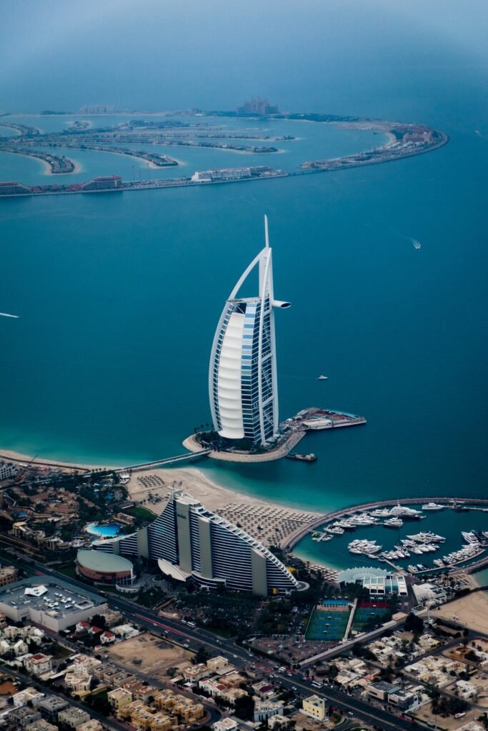 Study in Other Countries: Study in the UAE, An iconic image of Burj Al Arab in Dubai, UAE. The luxurious sail-shaped hotel stands against the backdrop of the vibrant cityscape and the sparkling waters of the Arabian Gulf. The architectural masterpiece reflects modern elegance and extravagance, symbolizing Dubai's status as a global destination for opulence and innovation.