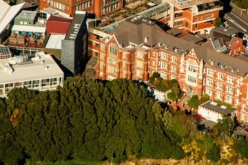 A vibrant scene showcasing the campus and surroundings of Victoria University of Wellington in New Zealand, blending academic excellence with natural beauty.