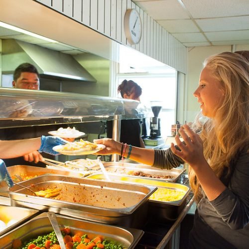 An ETC summer school student is taking her food.