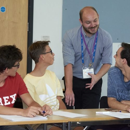 A tutor is lecturing at a summer school