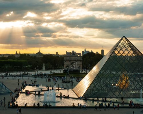 Exterior view of the Louvre Museum in Paris, showcasing its grand architecture and cultural significance.