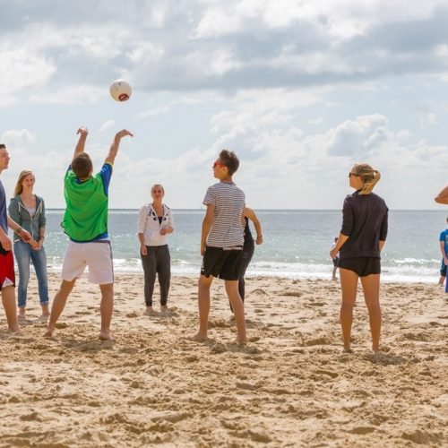 Cavendish summer school students are playing volleyball at Bournemouth beach.