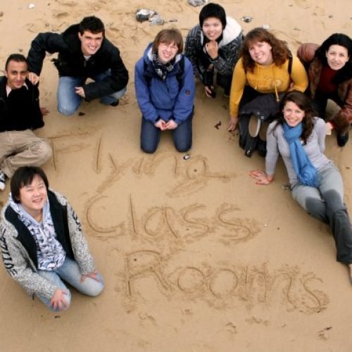 Students of Flying classrooms summer schools at a beach.