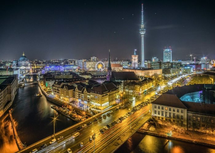 A captivating view of the city lights illuminating the iconic landmarks in Germany's capital.